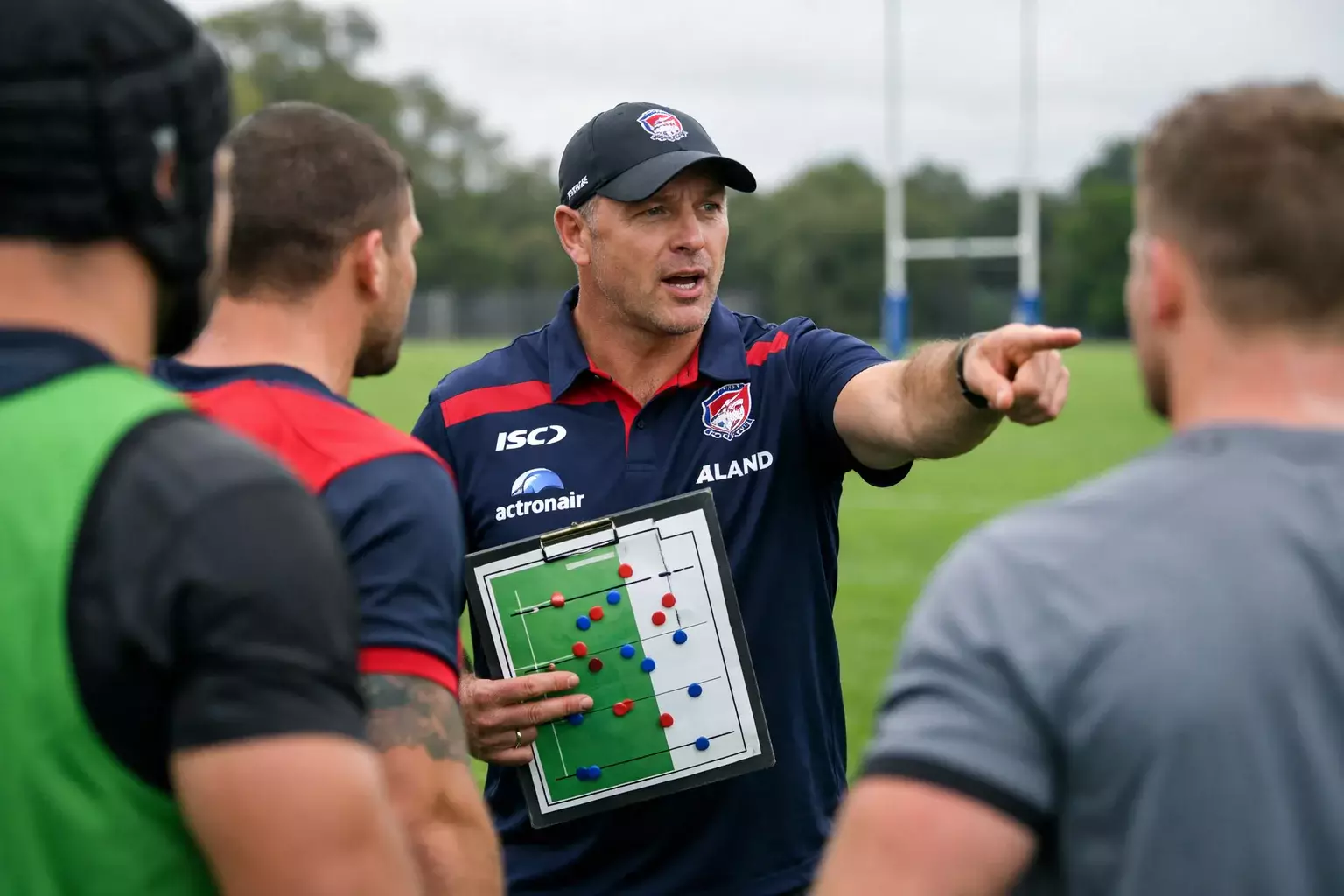 Rugby league coach reviewing game strategy with players